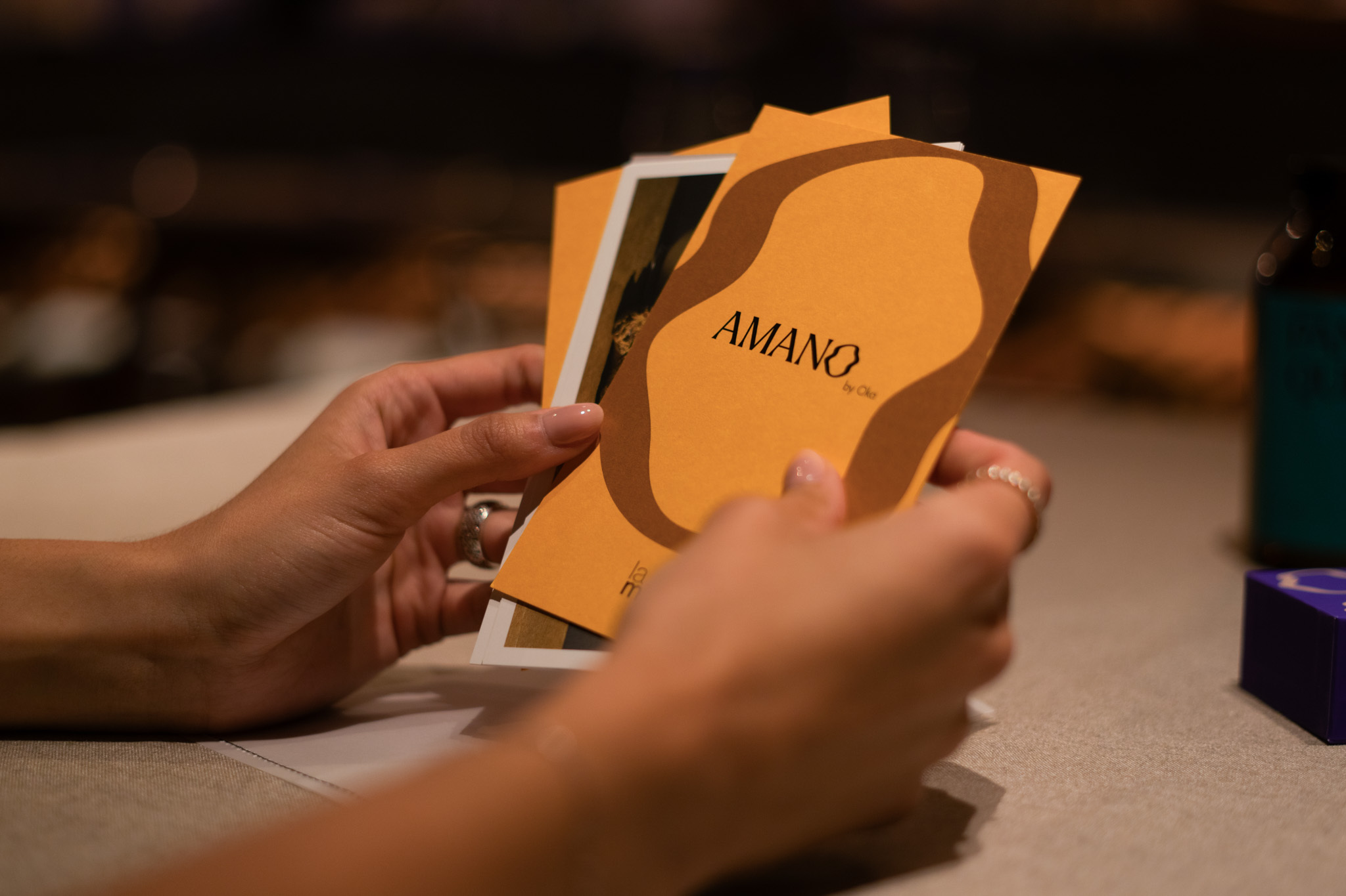 Diego Oka holding Amano design flyers