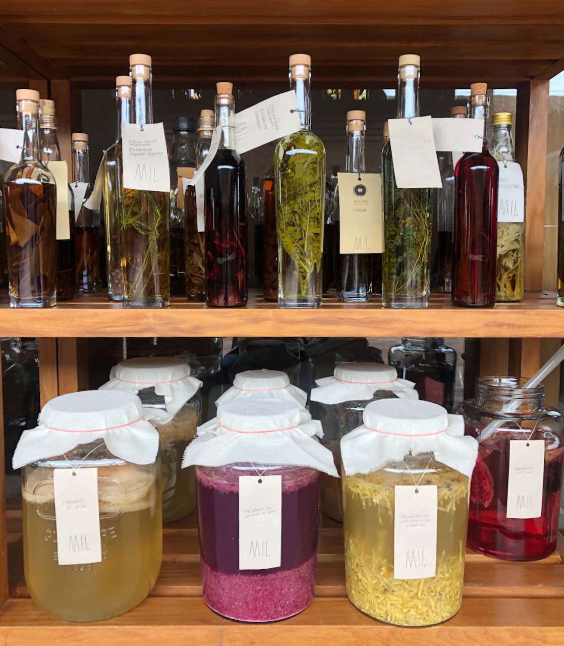 A shelve with bottles of different ferments.