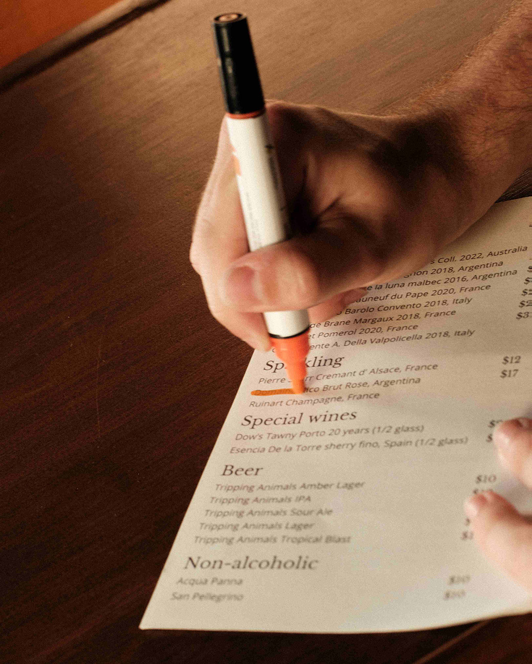 The chef modifying the menu with a marker.