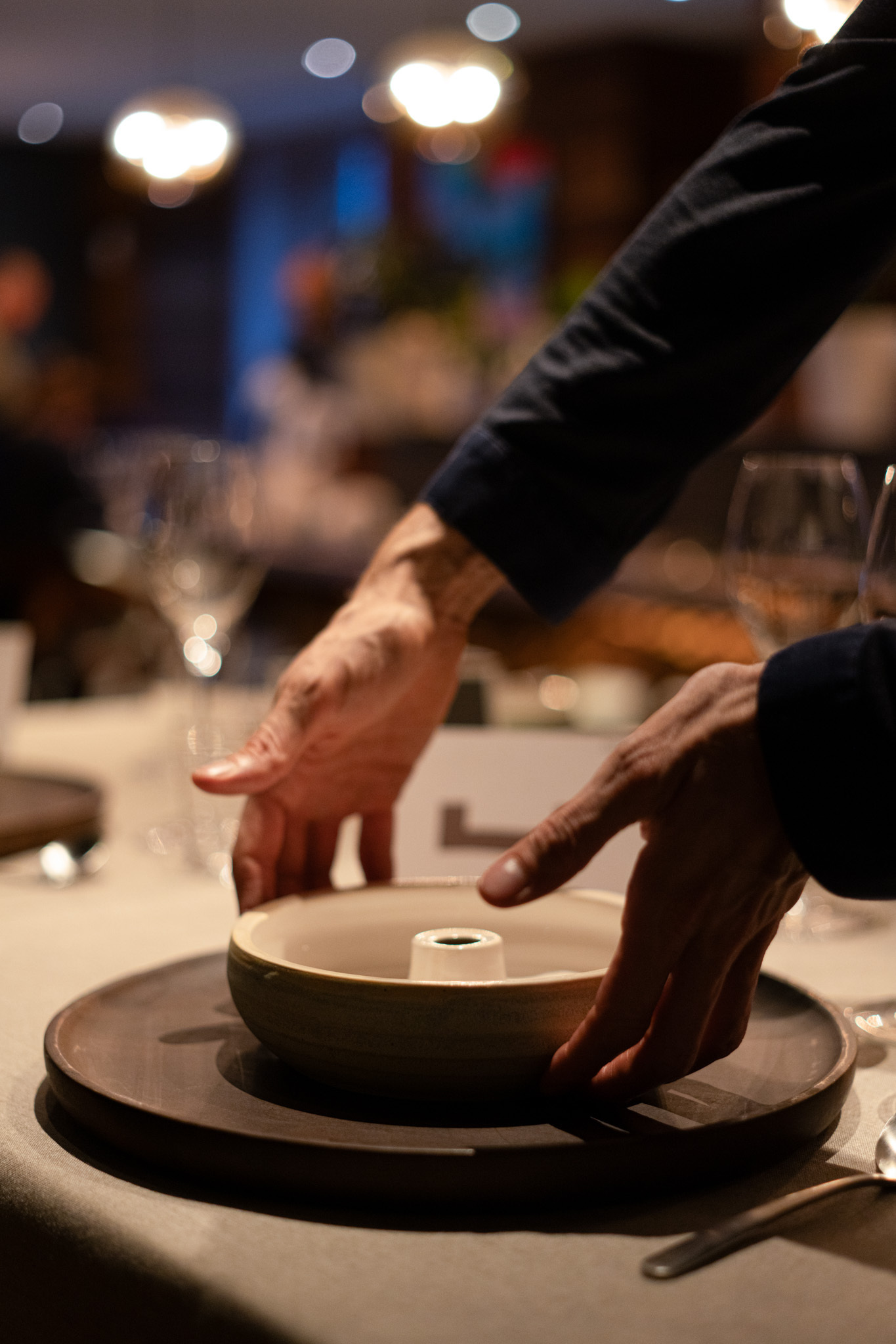 Waiter serving a plate from Amano
